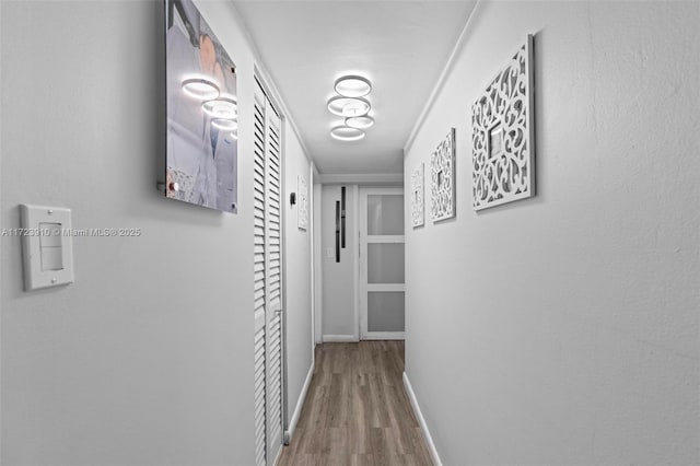 corridor with hardwood / wood-style floors