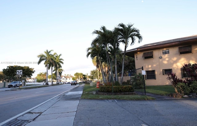 6850 NW 173rd Dr Unit 103, Hialeah, FL 33015 - view of asphalt road with sidewalks and traffic signs