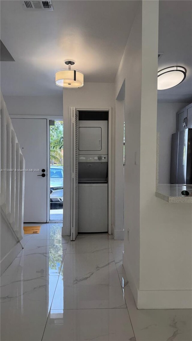 6850 NW 173rd Dr Unit 103, Hialeah, FL 33015 - corridor featuring estacked washer and dryer and light marble finish flooring