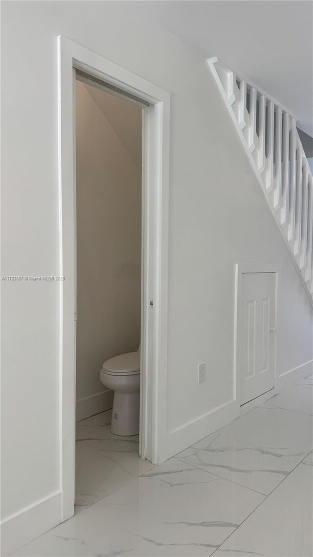 6850 NW 173rd Dr Unit 103, Hialeah, FL 33015 - bathroom featuring marble look tiles and baseboards