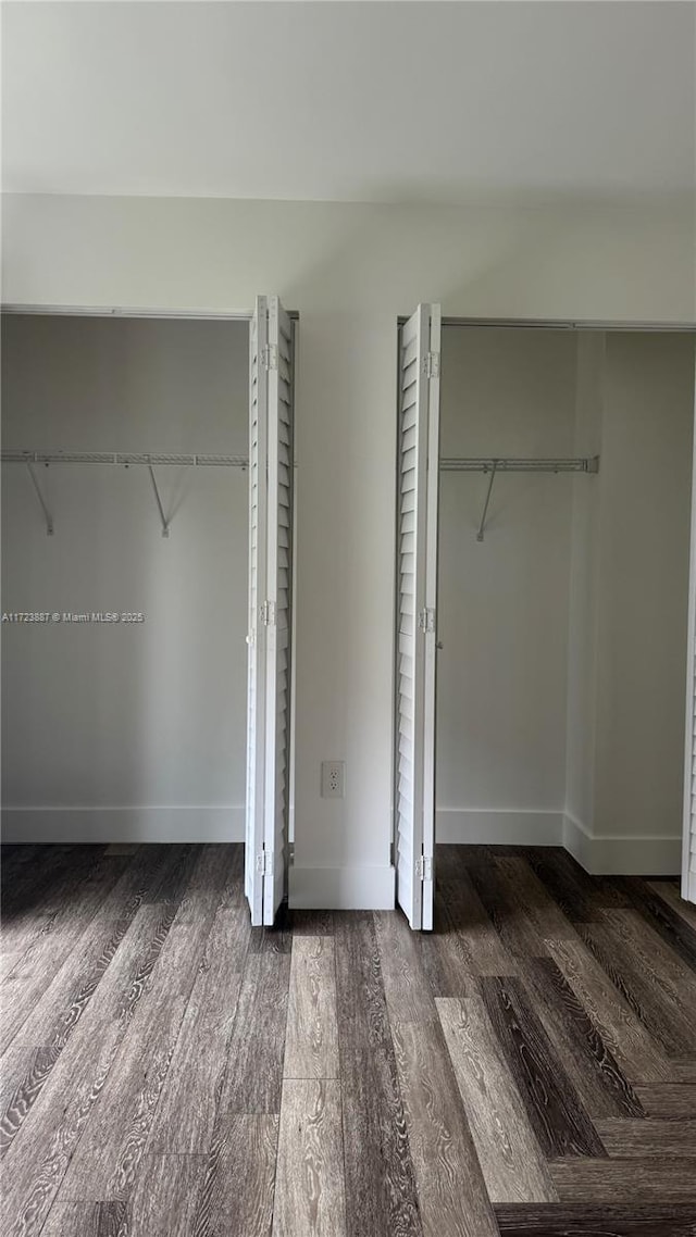 6850 NW 173rd Dr Unit 103, Hialeah, FL 33015 - unfurnished bedroom featuring wood finished floors and a closet