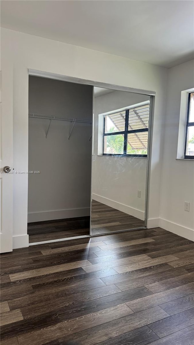 6850 NW 173rd Dr Unit 103, Hialeah, FL 33015 - unfurnished bedroom featuring dark wood-style floors and a closet