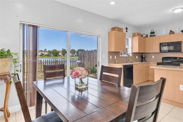 tiled dining room featuring sink