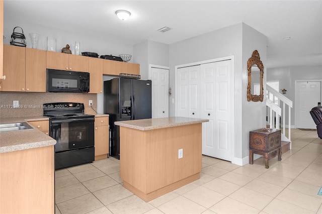 kitchen with a center island, black appliances, light brown cabinetry, tasteful backsplash, and light tile patterned flooring