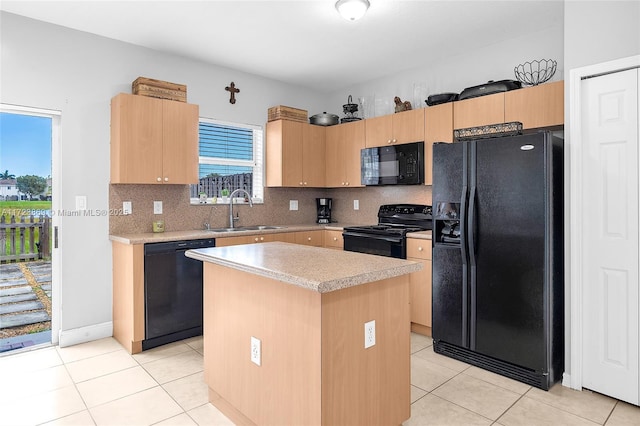 kitchen featuring light tile patterned flooring, black appliances, sink, decorative backsplash, and a kitchen island