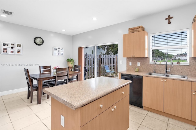 kitchen with dishwasher, sink, decorative backsplash, light tile patterned floors, and a kitchen island