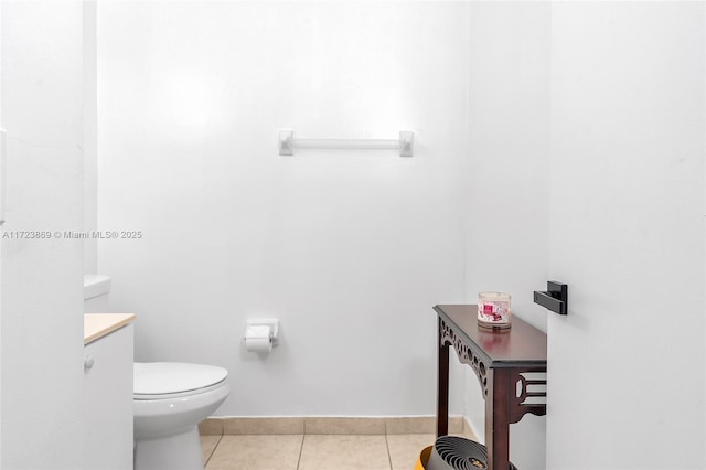 bathroom with tile patterned flooring, vanity, and toilet