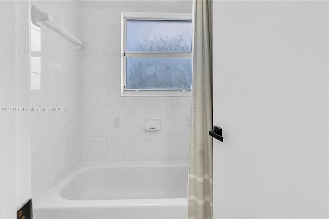 bathroom with shower / bath combo with shower curtain