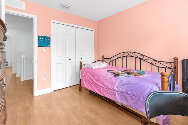 bedroom featuring light wood-type flooring and a closet