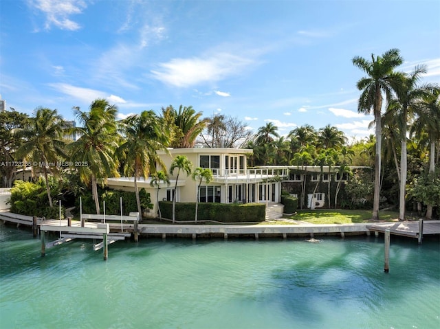 back of house with a water view and a balcony