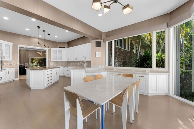 dining room featuring sink and a chandelier