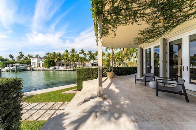 view of patio / terrace with french doors and a water view