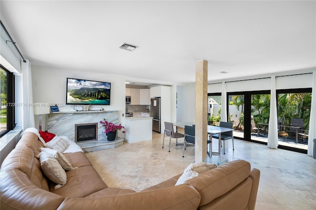 living room with french doors and a premium fireplace