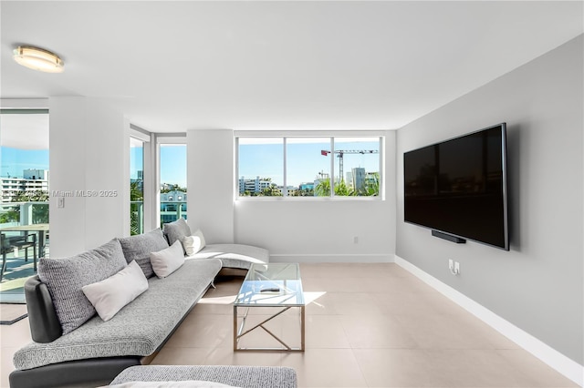 living room with plenty of natural light and light tile patterned floors