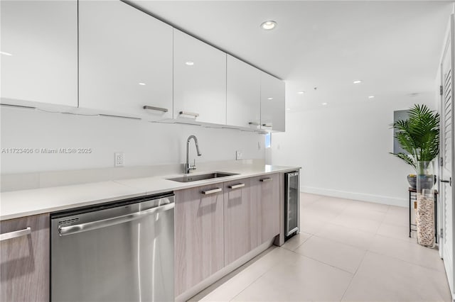 kitchen featuring white cabinets, sink, light tile patterned floors, dishwasher, and wine cooler