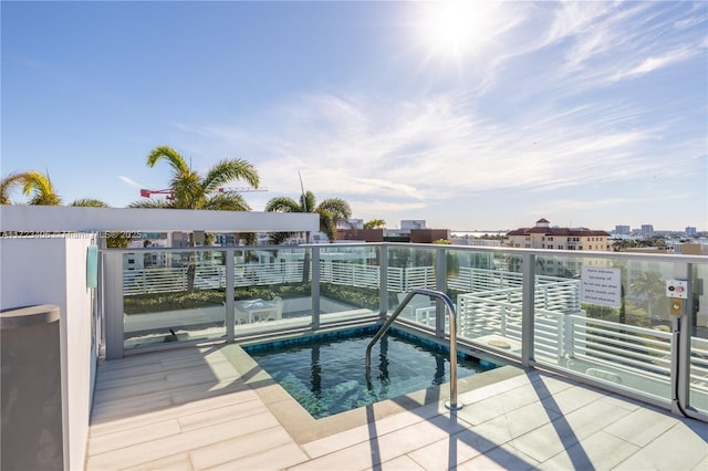 view of swimming pool featuring a hot tub