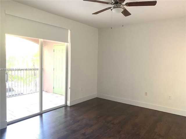 spare room with ceiling fan and dark hardwood / wood-style flooring