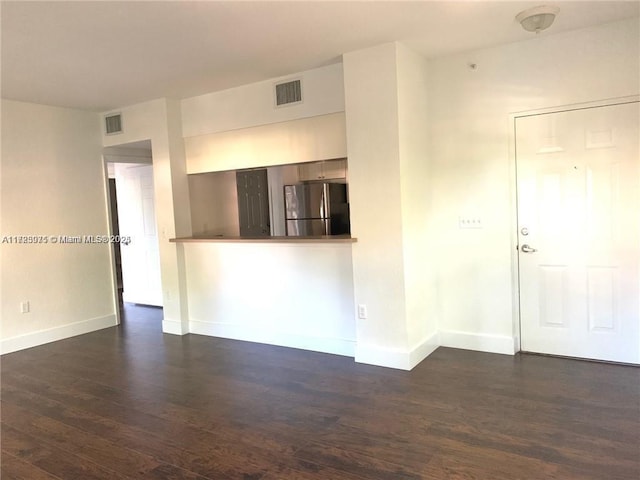 empty room with dark hardwood / wood-style floors