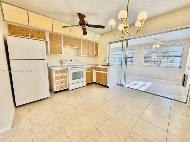 kitchen featuring ceiling fan with notable chandelier, pendant lighting, white appliances, and light tile patterned floors