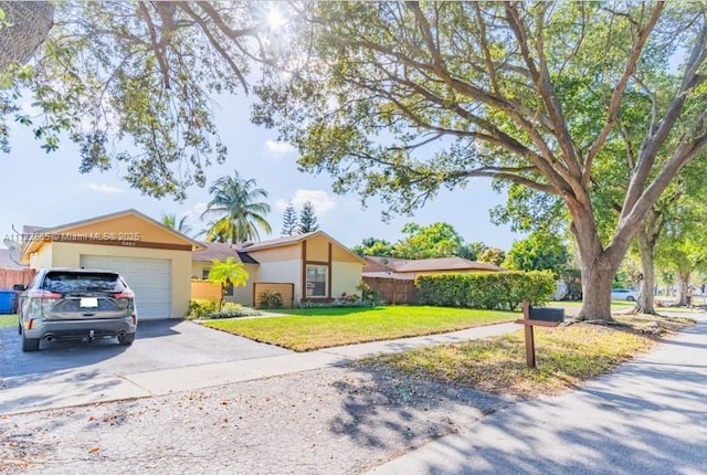 ranch-style home with a garage and a front lawn