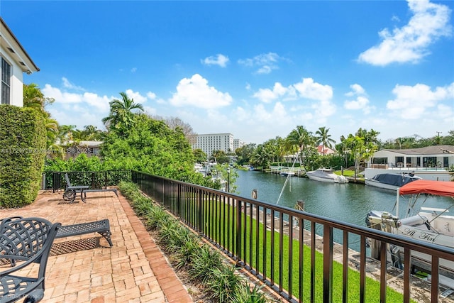 balcony with a water view and a dock