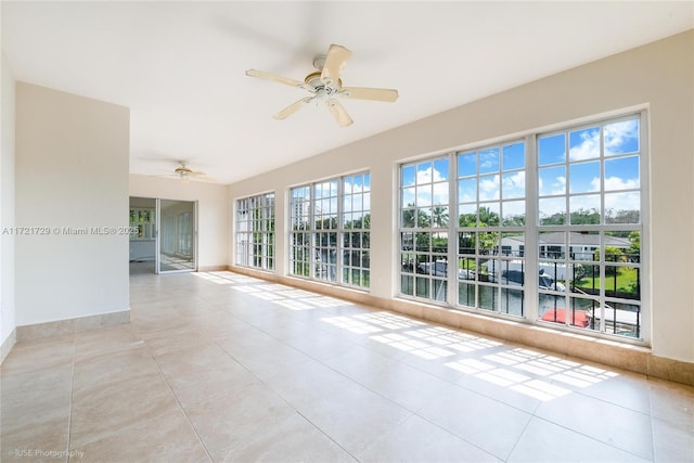 unfurnished room with ceiling fan and light tile patterned floors