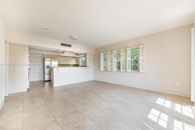 unfurnished living room with light tile patterned flooring