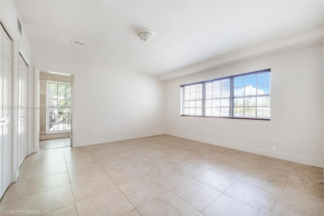 spare room featuring light tile patterned floors