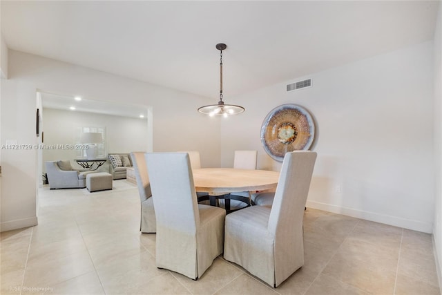 tiled dining space featuring a notable chandelier