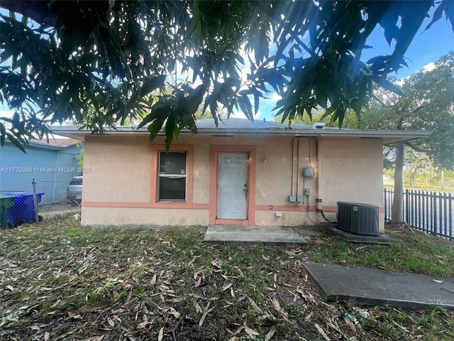 rear view of house featuring cooling unit