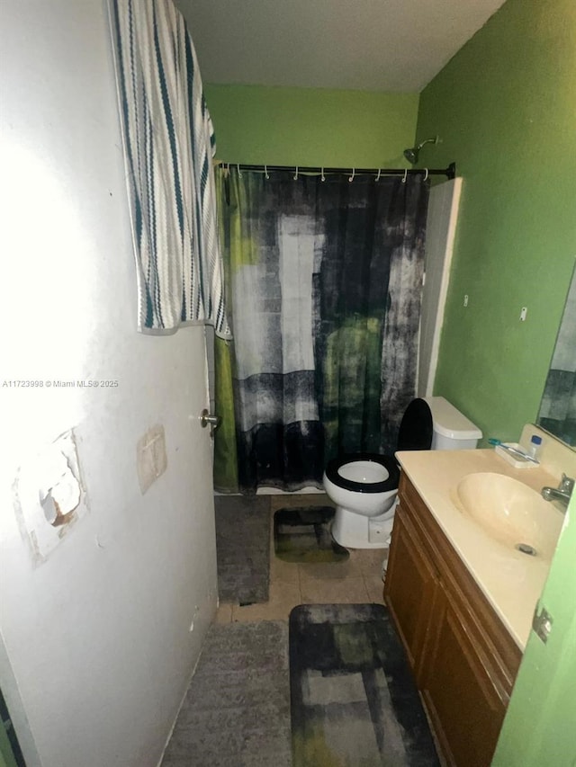 bathroom with tile patterned floors, vanity, and toilet