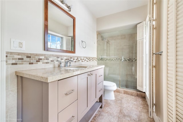 bathroom with an enclosed shower, vanity, tile walls, tile patterned flooring, and toilet