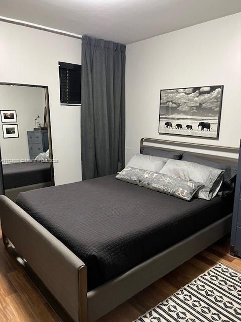 bedroom featuring dark hardwood / wood-style floors