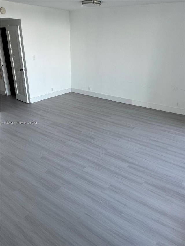 spare room featuring dark wood-type flooring