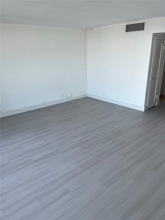 unfurnished room with dark hardwood / wood-style floors