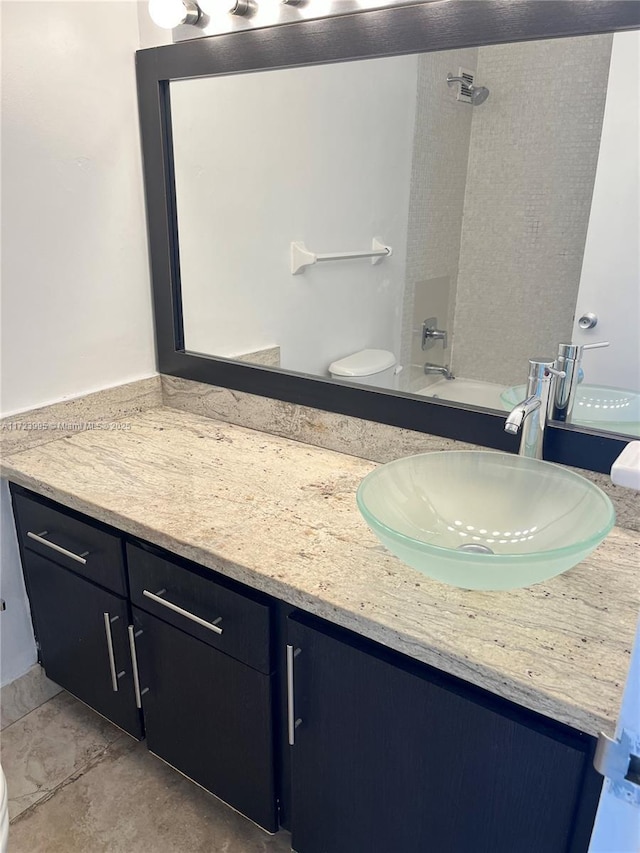 full bathroom with tile patterned floors, vanity, and toilet