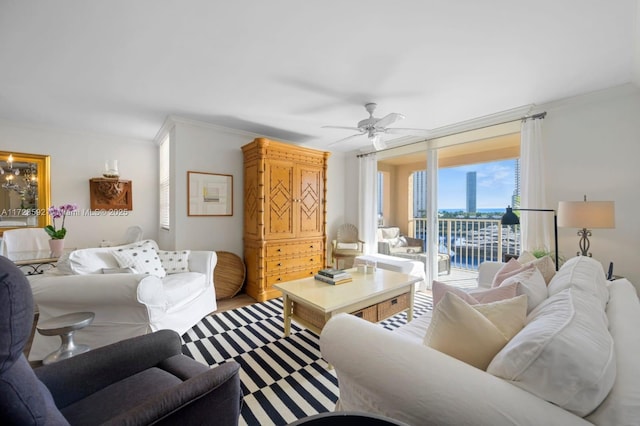 living room featuring a water view, ceiling fan, and ornamental molding