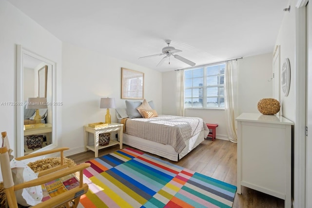 bedroom with hardwood / wood-style floors and ceiling fan