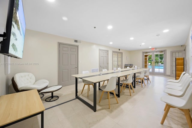 tiled dining room featuring french doors