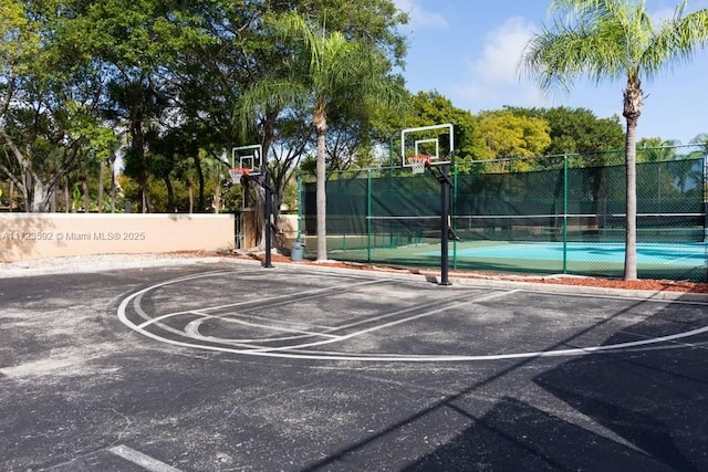 view of sport court featuring tennis court