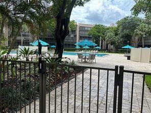 exterior space featuring a fenced in pool and a patio