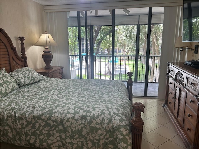 bedroom featuring access to exterior and light tile patterned floors