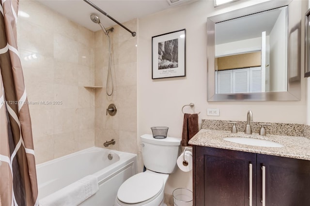 full bathroom featuring shower / bath combo with shower curtain, vanity, and toilet