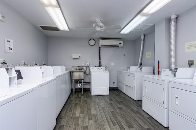 clothes washing area featuring independent washer and dryer, dark hardwood / wood-style flooring, an AC wall unit, and ceiling fan