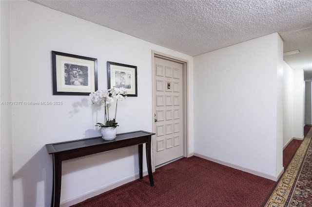 interior space with dark carpet and a textured ceiling