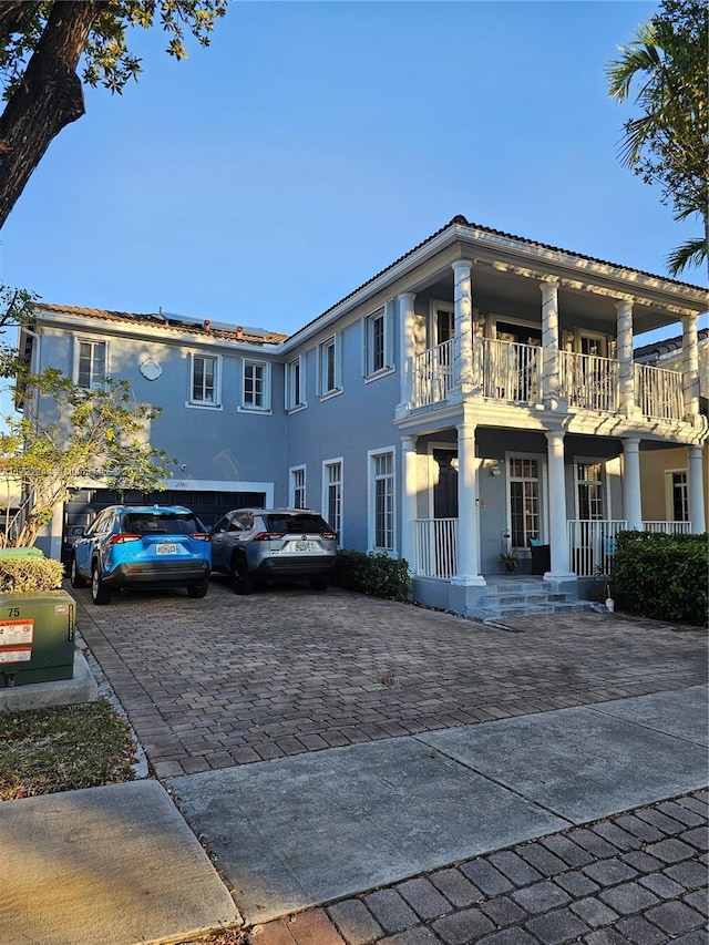 view of front of property with a balcony and a porch