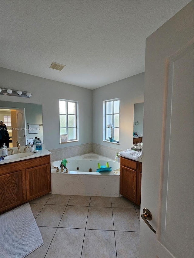 bathroom featuring a textured ceiling, vanity, and tile patterned flooring