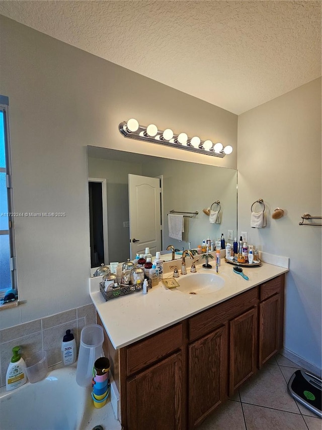 bathroom featuring vanity, tile patterned flooring, and a textured ceiling