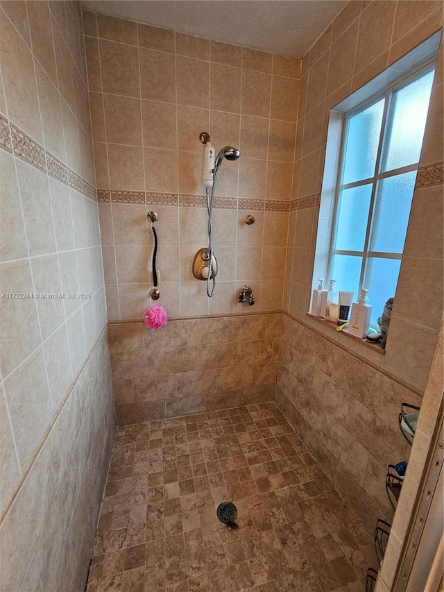 bathroom with tiled shower