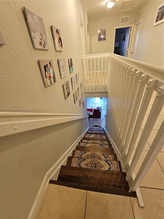 staircase with tile patterned floors